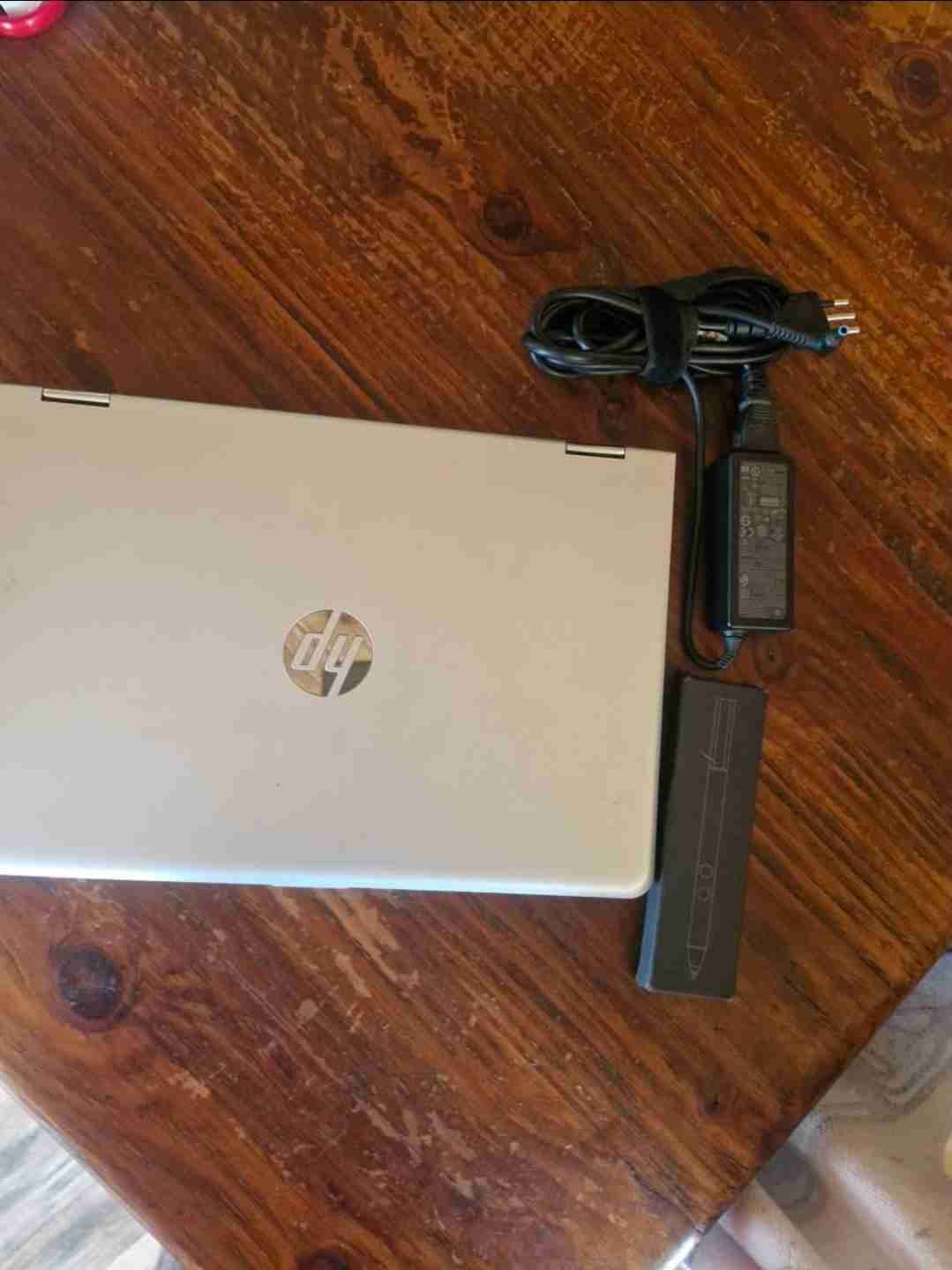 Laptop HP con cargador y lápiz