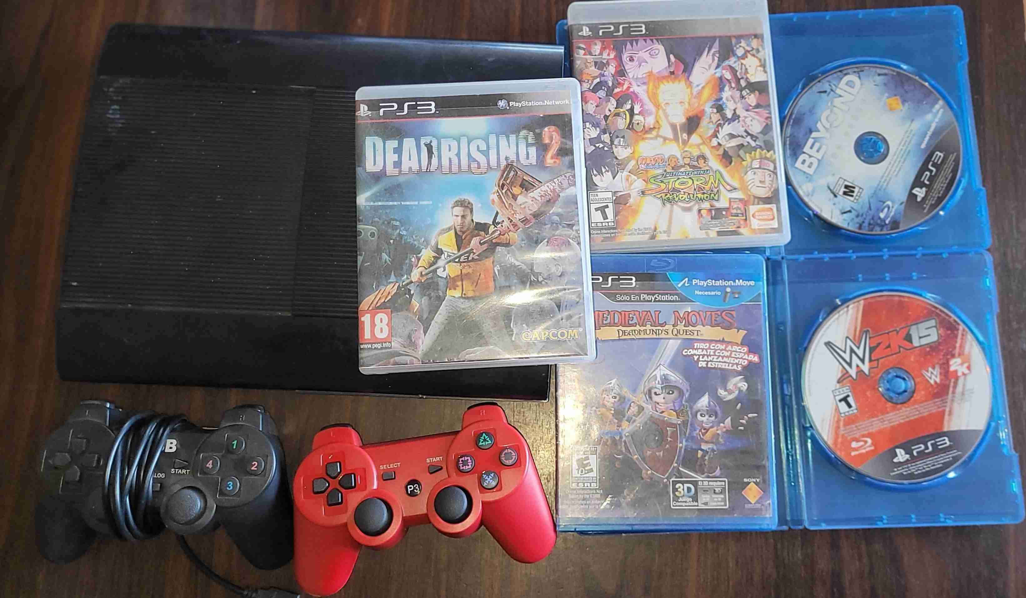 Consola PS3 con juegos y controles - miniatura 1