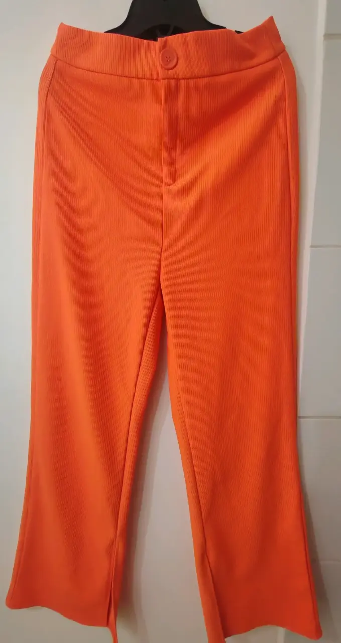 Pantalones naranjas con textura - miniatura 1
