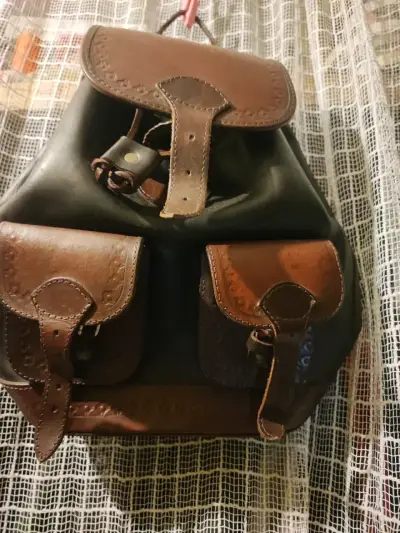 Mochila de cuero tonos café claro y café oscuro. - miniatura 1
