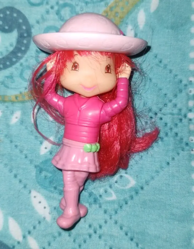 Muñeca pequeña con sombrero rosa