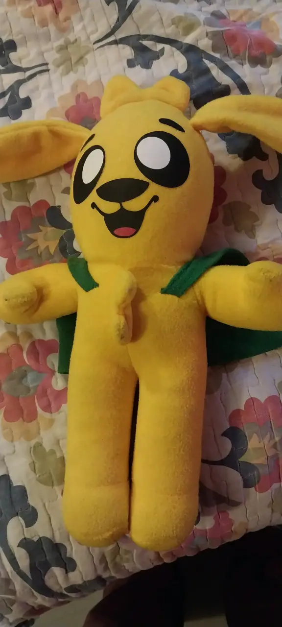 Peluche amarillo con capa verde