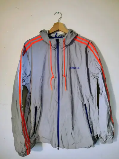 Cortaviento adidas gris con naranja reflectante - miniatura 1