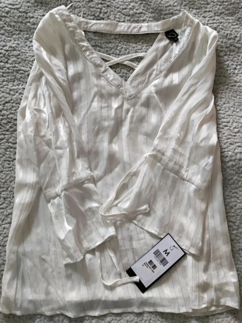 Blusa blanca con rayas y detalle