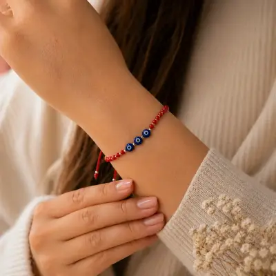 Pulsera roja con dije ojo turco - miniatura 1