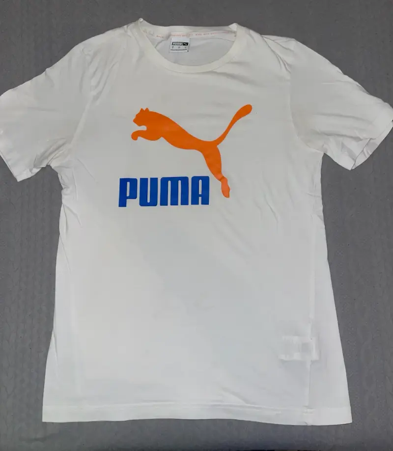 Polera Puma blanca con logo naranja - 1