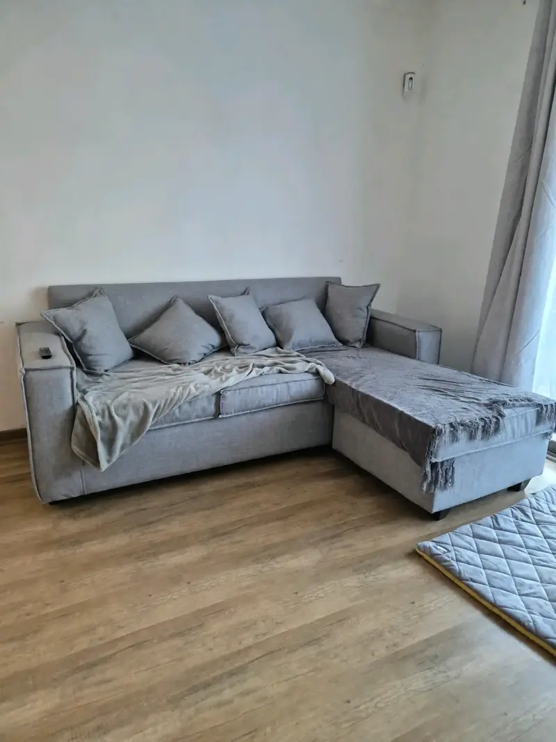 Sofá seccional gris con cojines