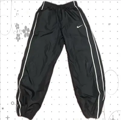 Pantalones deportivos Nike azul con franjas - miniatura 1
