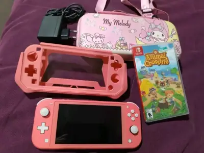 Nintendo Switch Lite coral con juego Animal Crossing - miniatura 1