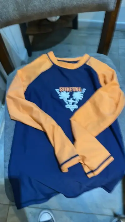 Polera manga larga azul y naranja para surf - miniatura 1