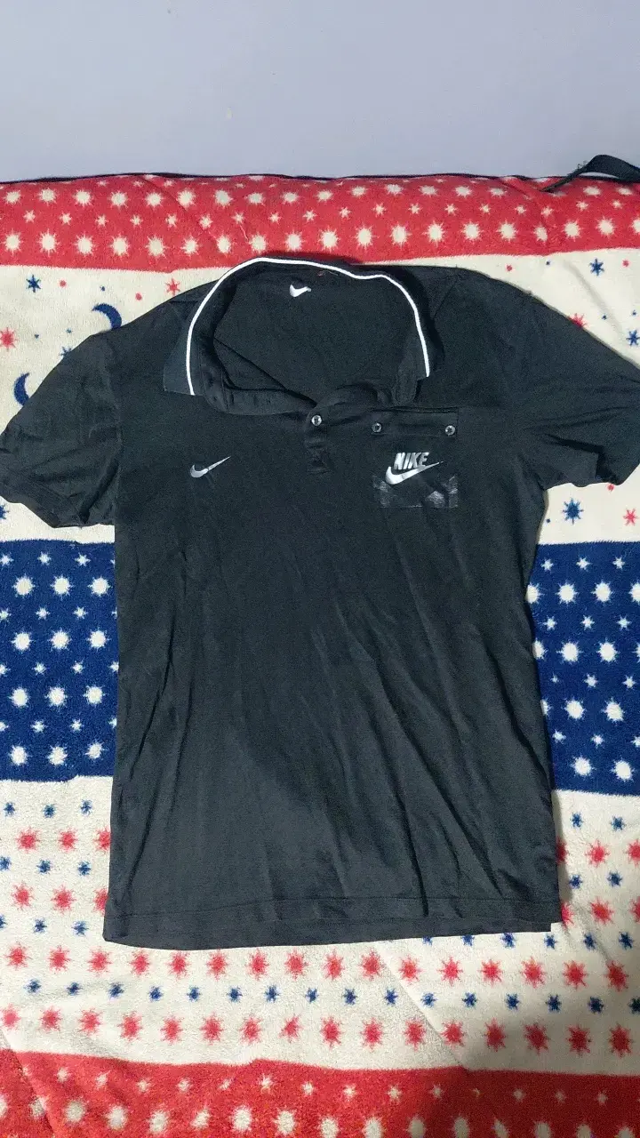 Polera polo Nike negra con logo - 1