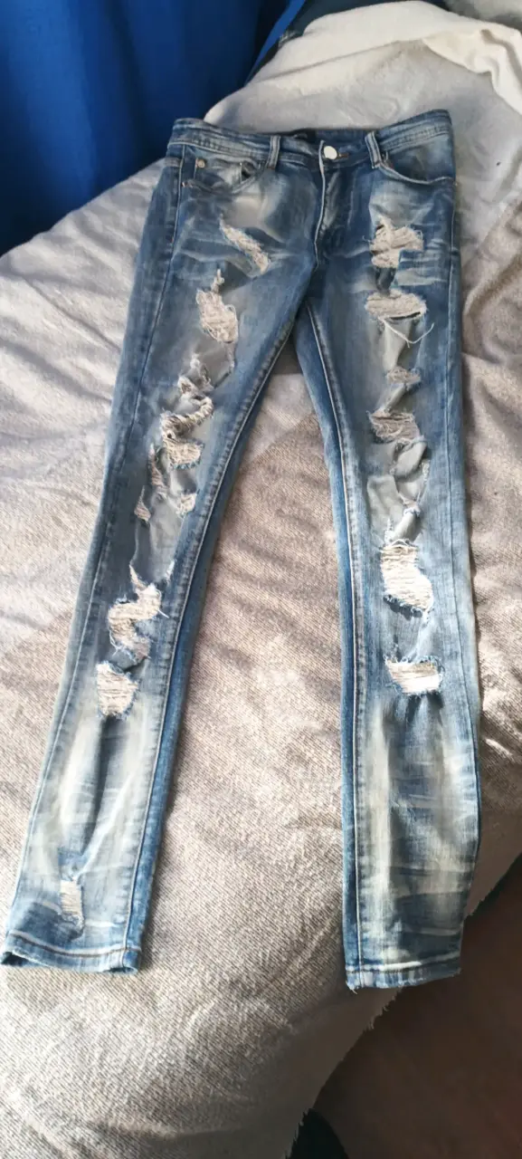 Jeans desgastados de mezclilla azul - 1