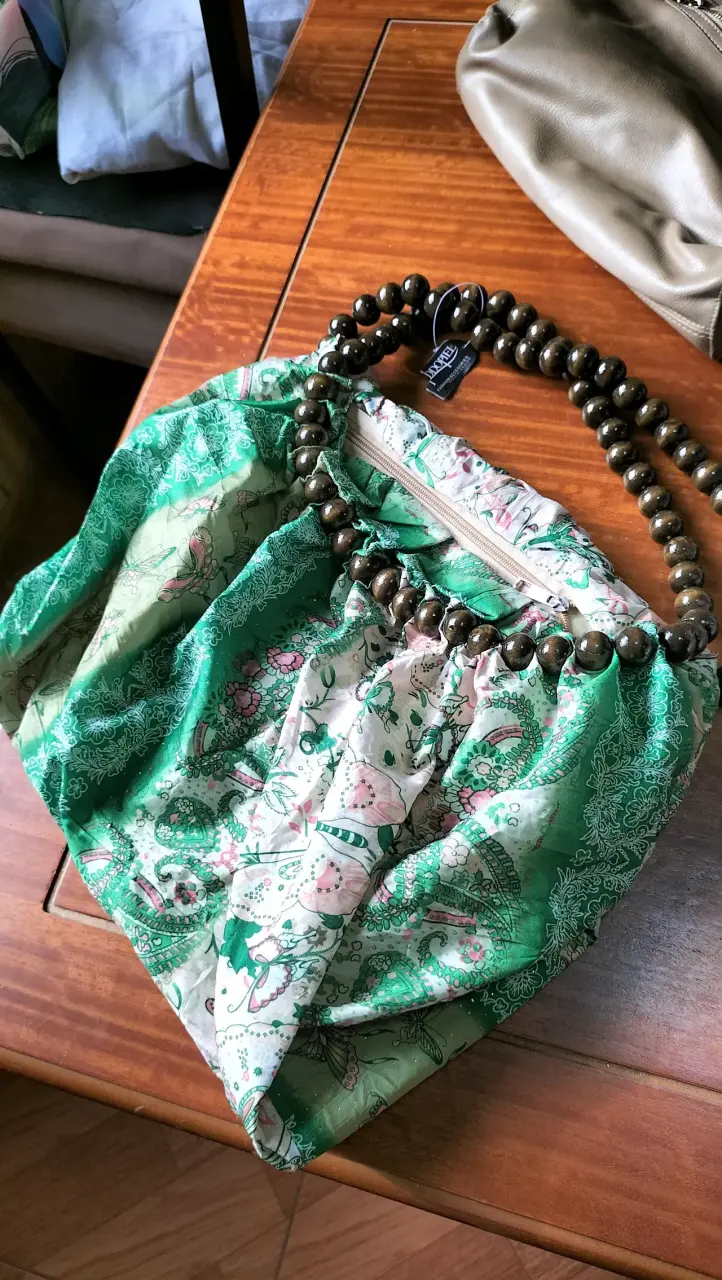 Bolso de tela verde con asa de cuentas