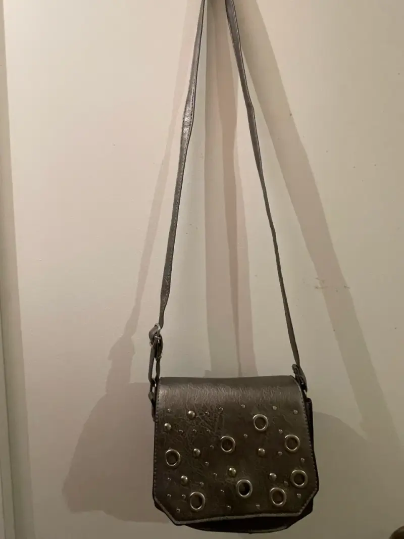 Cartera bandolera gris con apliques metálicos
