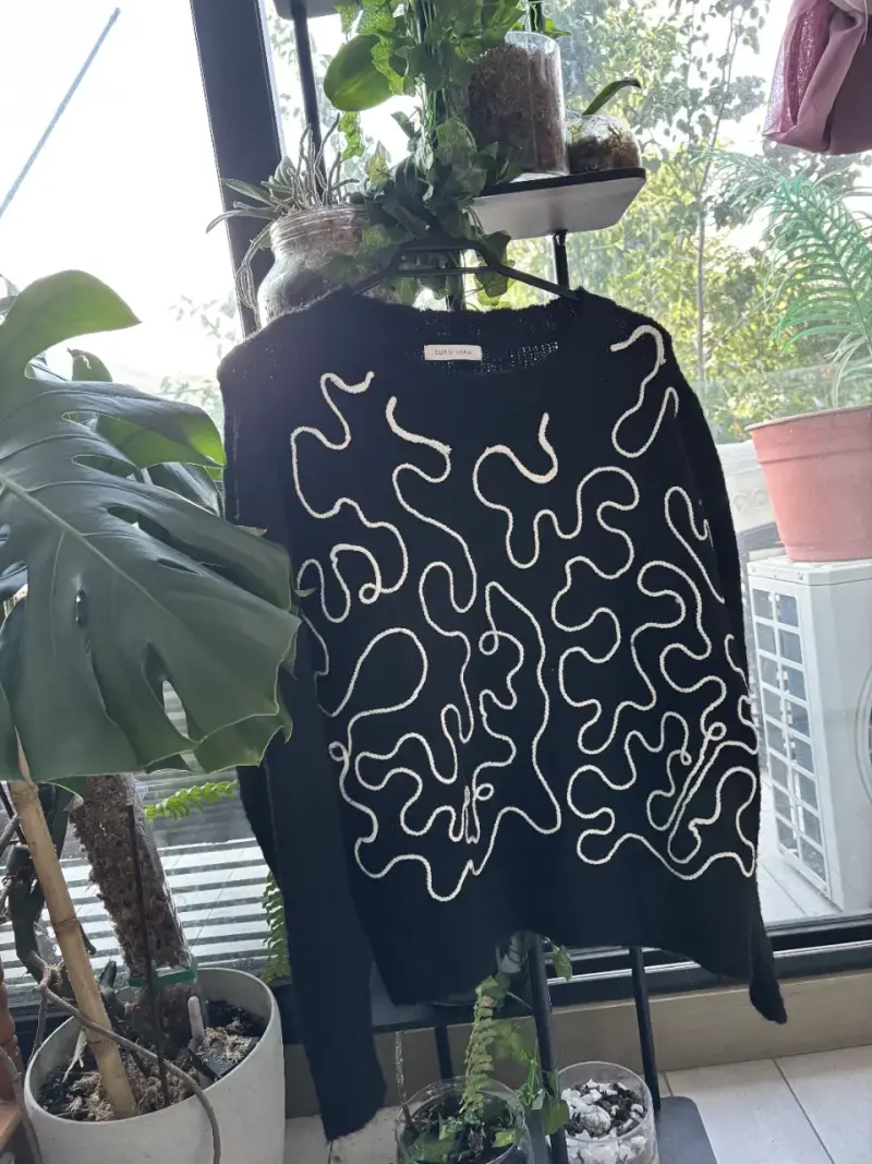 Suéter negro con diseño abstracto