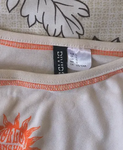 Polera beige con diseño de sol naranja H&M - miniatura 3
