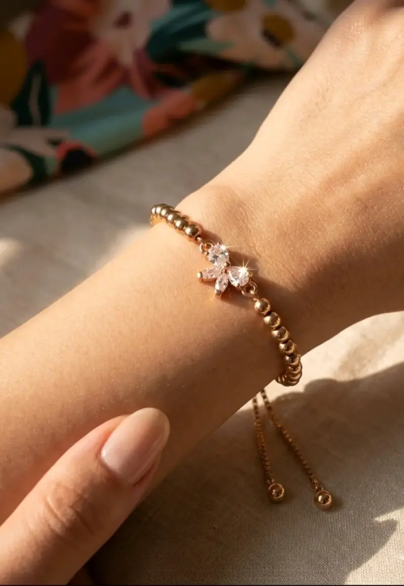 Pulsera de oro rosa con dije de lazo
