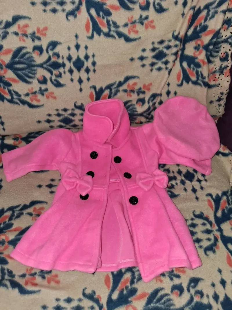 Abrigo infantil rosa con botones decorativos