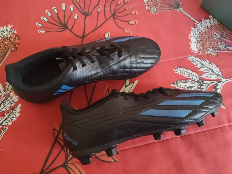 Botines de fútbol negros con detalles azules - 1