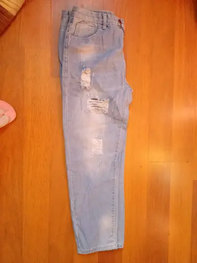 Jeans desgastados de mezclilla azul claro - miniatura 1