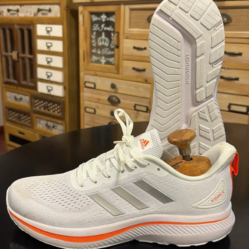Zapatillas deportivas Adidas blancas con detalles naranjas