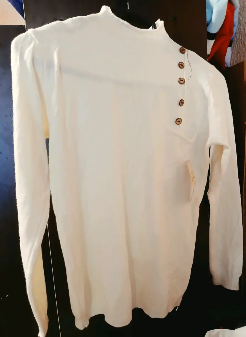 Suéter blanco con botones decorativos
