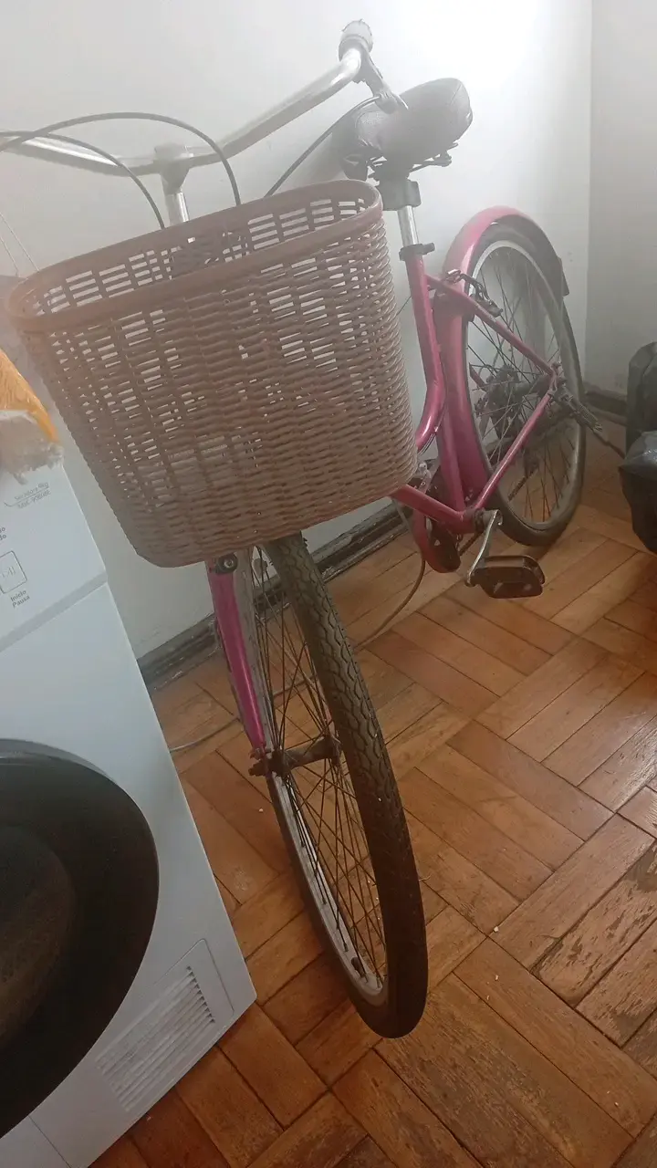 Bicicleta urbana rosada con canasto delantero
