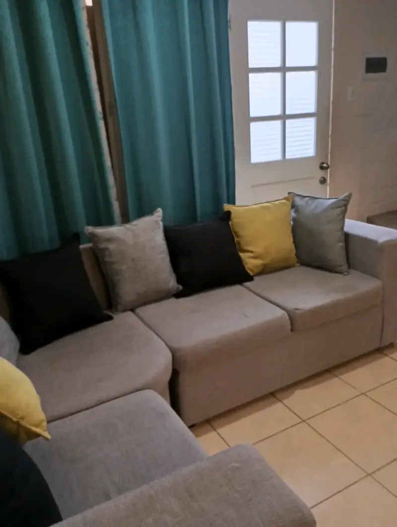 Sofá seccional gris con cojines decorativos - 3