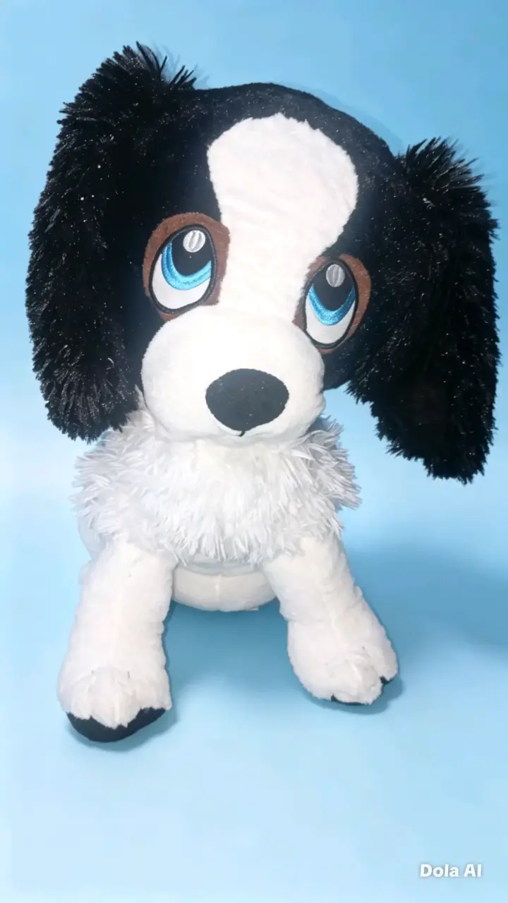 Peluche de perro blanco y negro con ojos grandes