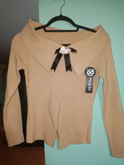 Suéter beige con lazo decorativo - miniatura 1