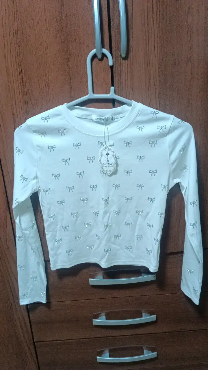 Polera manga larga blanca con lazos para niña