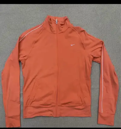 Chaqueta deportiva Nike Fit naranja para mujer - miniatura 1