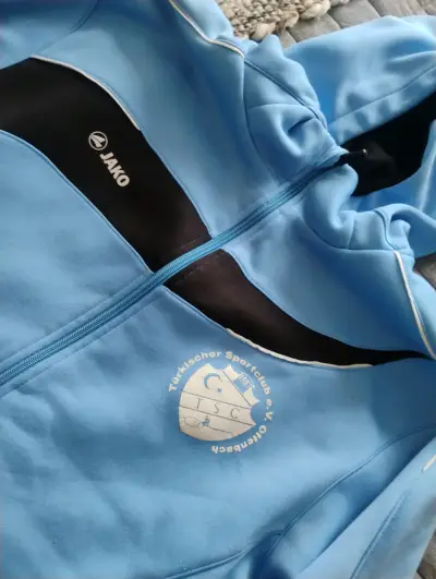 Chaqueta deportiva azul Jako con capucha - miniatura 1