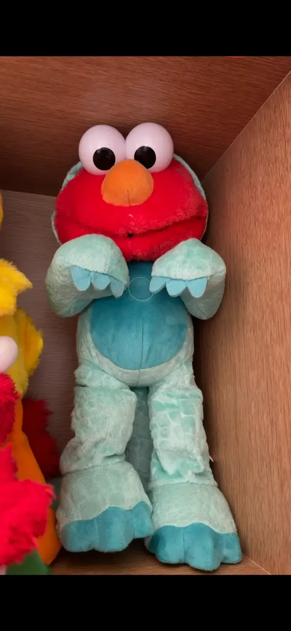 Peluche Elmo disfraz de dinosaurio funcional