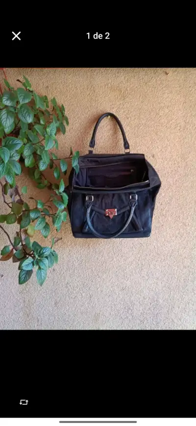 Bolso negro de cuero con cierre metálico - miniatura 1
