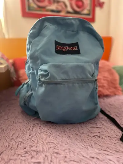 Mochila Jansport azul claro en buen estado - miniatura 1