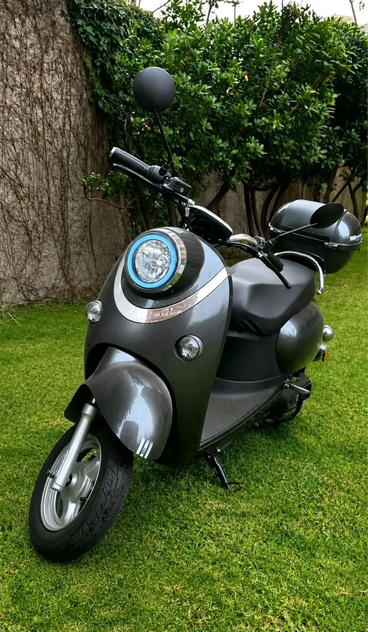 Scooter eléctrico gris con maletero