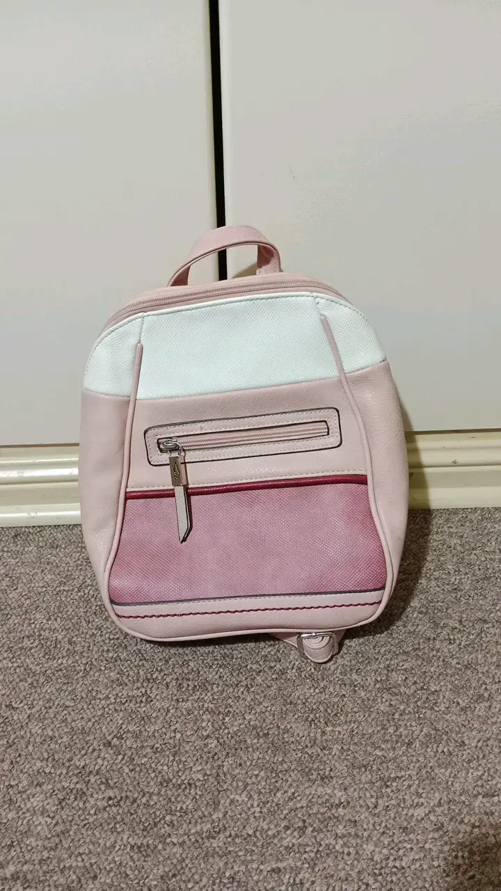 Mochila pequeña rosa y blanca con bolsillos