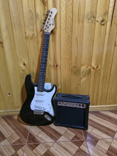 Guitarra eléctrica negra con amplificador - miniatura 4