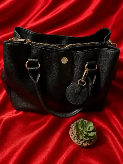 Bolso de cuero negro con detalles dorados - miniatura 1