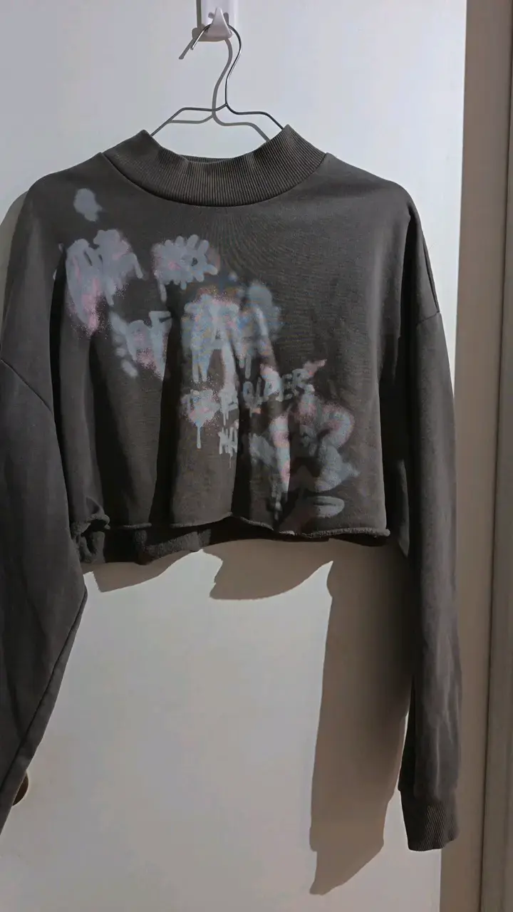 Polerón corto gris con diseño gráfico