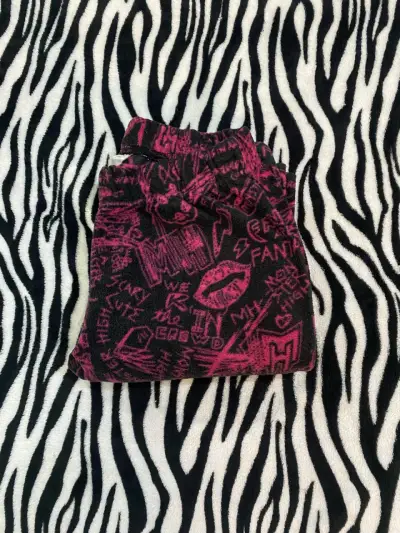 Pantalones estampados negros y rosados para niña - miniatura 1