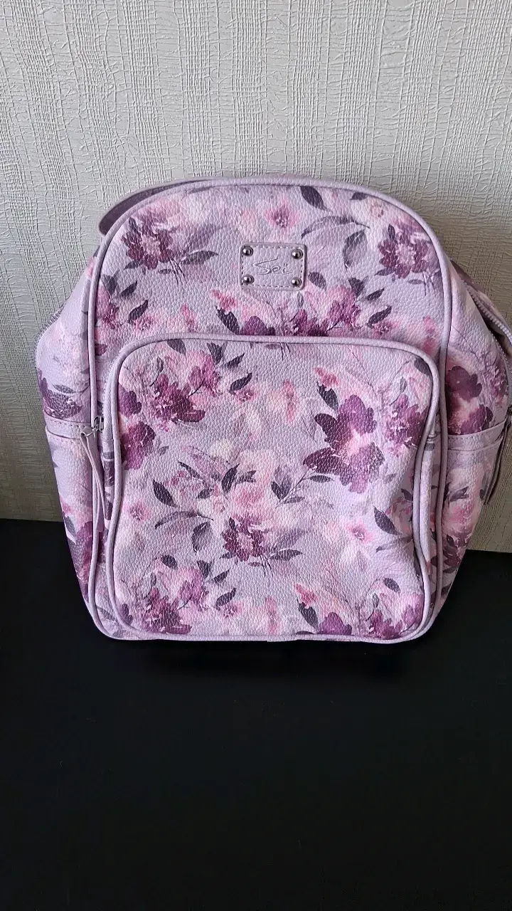 Mochila floral rosada de mujer