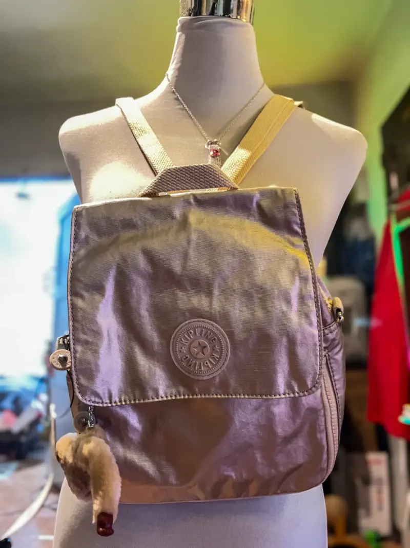 Mochila Kipling color beige con llavero de mono