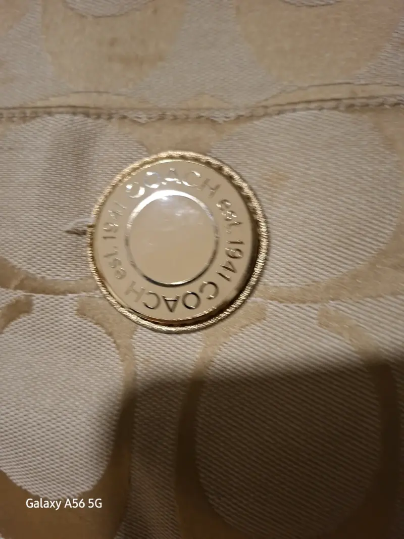 Bolso tote Coach beige con detalles dorados