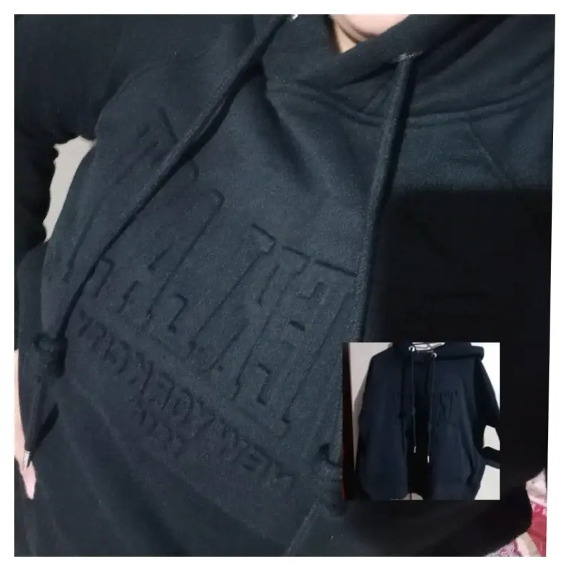 Polerón negro con capucha y diseño frontal