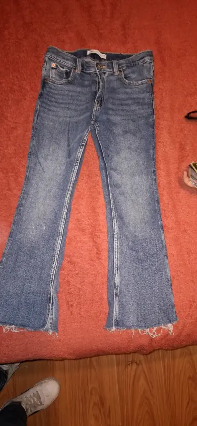 Jeans acampanados de mezclilla azul desgastados - miniatura 1