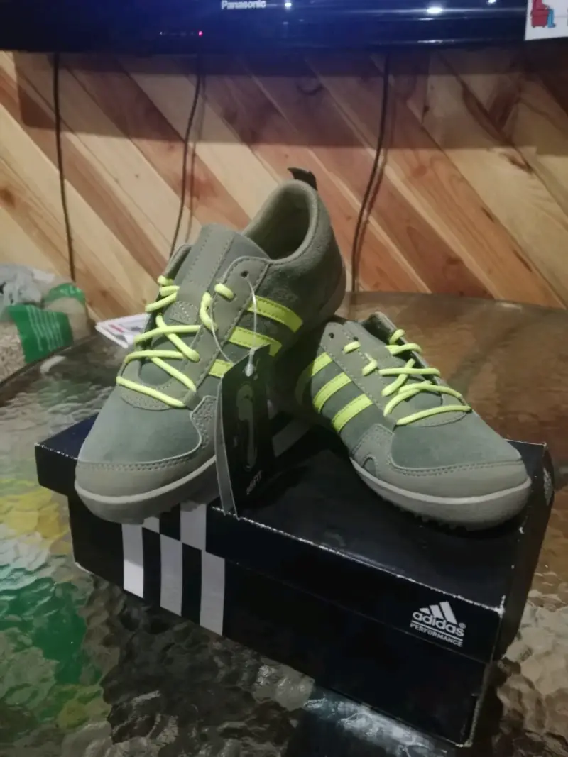 Zapatillas deportivas Adidas verdes con detalles amarillos