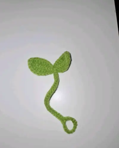 Accesorio tejido verde para audífonos - miniatura 1