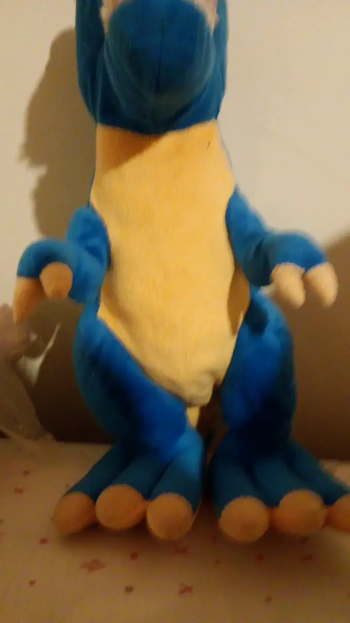 Peluche de dinosaurio azul y amarillo